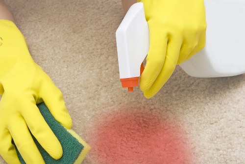 Technician preparing carpet cleaning equipment safely indoors